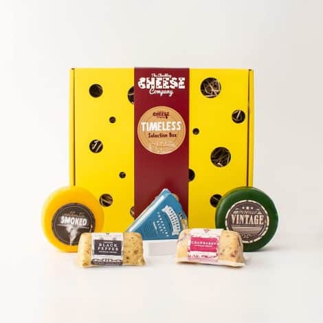 Luxurious cheese gift box filled with a variety of wax truckle and barrel cheddar cheese, perfect for unique gifting.