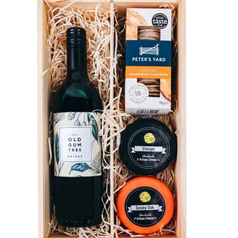 Cheese and Wine Gift Bundle: Ideal combination of Shiraz Red Wine, 2 round cheese portions, and crackers hamper.